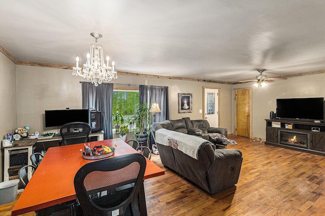 7694 Norconk Rd, Bear Lake, MI 49614 - living room featuring a chandelier, wood finished floors, ceiling fan, crown molding, and wine cooler