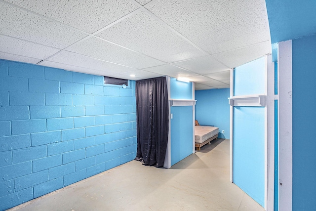 7694 Norconk Rd, Bear Lake, MI 49614 - finished basement with a paneled ceiling and concrete block wall