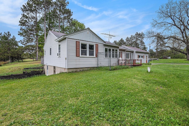 7694 Norconk Rd, Bear Lake, MI 49614 - view of front facade with a front yard, board and batten siding, and a deck