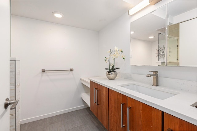 202 Orchard Hills Dr, Ann Arbor, MI 48104 - bathroom featuring vanity, wood finished floors, baseboards, and a shower with shower door