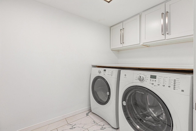 202 Orchard Hills Dr, Ann Arbor, MI 48104 - washroom with washing machine and clothes dryer, cabinet space, light marble finish floors, and baseboards