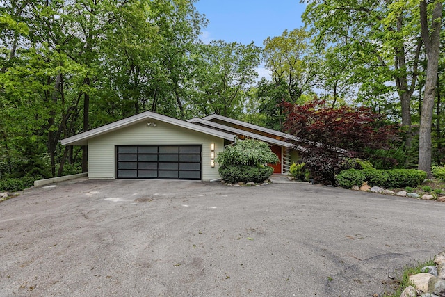 202 Orchard Hills Dr, Ann Arbor, MI 48104 - mid-century inspired home featuring an attached garage and asphalt driveway