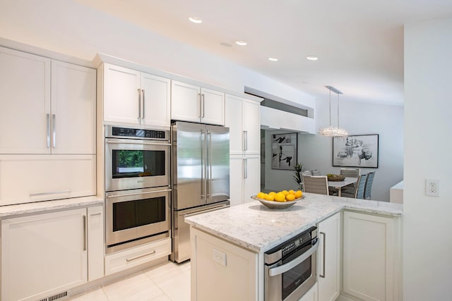 202 Orchard Hills Dr, Ann Arbor, MI 48104 - kitchen featuring stainless steel appliances, light stone countertops, white cabinets, decorative light fixtures, and light tile patterned floors
