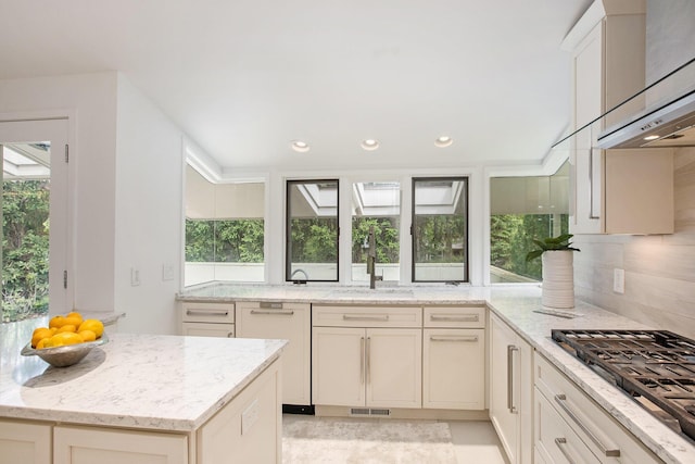 202 Orchard Hills Dr, Ann Arbor, MI 48104 - kitchen with extractor fan, stainless steel gas cooktop, a sink, light stone countertops, and plenty of natural light
