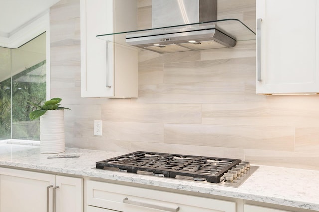 202 Orchard Hills Dr, Ann Arbor, MI 48104 - kitchen with range hood, stainless steel gas cooktop, tasteful backsplash, white cabinetry, and light stone countertops