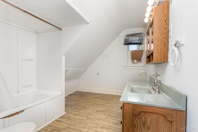 1508 Mckinley St, Bay City, MI 48708 - bathroom with vanity, wood finished floors, lofted ceiling, shower / bathtub combination with curtain, and baseboards
