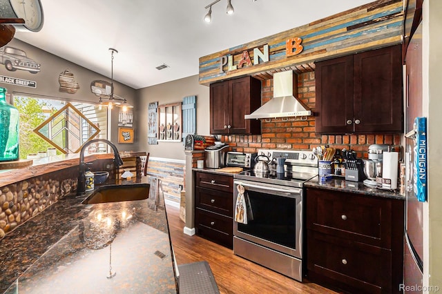 313 Spring Brooke Dr, Brighton, MI 48116 - kitchen featuring stainless steel range with electric cooktop, wall chimney range hood, a sink, dark brown cabinetry, and wood finished floors