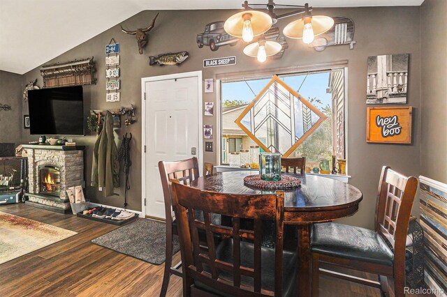 313 Spring Brooke Dr, Brighton, MI 48116 - dining space with wood finished floors, lofted ceiling, a chandelier, and a fireplace