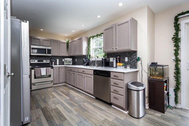 6075 Davison Rd, Burton, MI 48509 - kitchen featuring stainless steel appliances, gray cabinetry, a sink, and recessed lighting