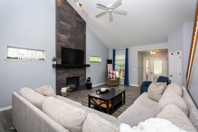 6075 Davison Rd, Burton, MI 48509 - living room featuring ceiling fan, wood finished floors, a high end fireplace, baseboards, and a towering ceiling