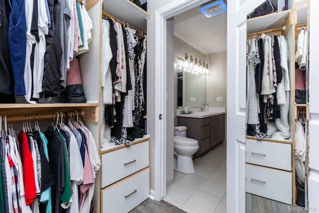 6075 Davison Rd, Burton, MI 48509 - spacious closet featuring a sink and light tile patterned floors