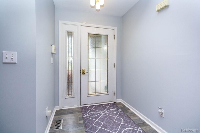 6075 Davison Rd, Burton, MI 48509 - foyer featuring baseboards and dark wood-type flooring