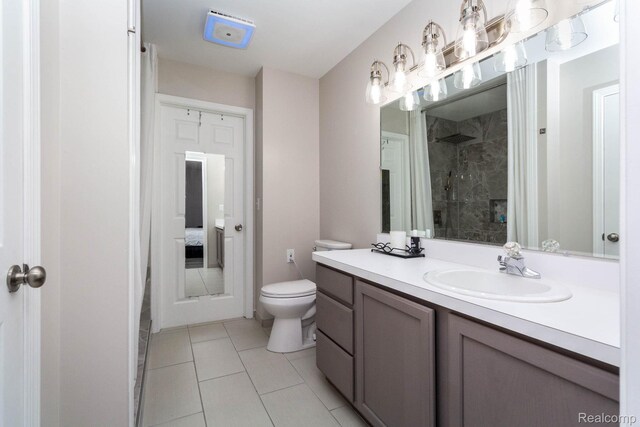 6075 Davison Rd, Burton, MI 48509 - full bathroom featuring vanity, a stall shower, toilet, and tile patterned floors