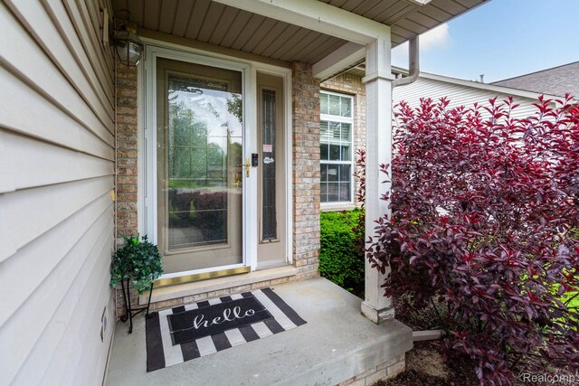 6075 Davison Rd, Burton, MI 48509 - doorway to property featuring covered porch