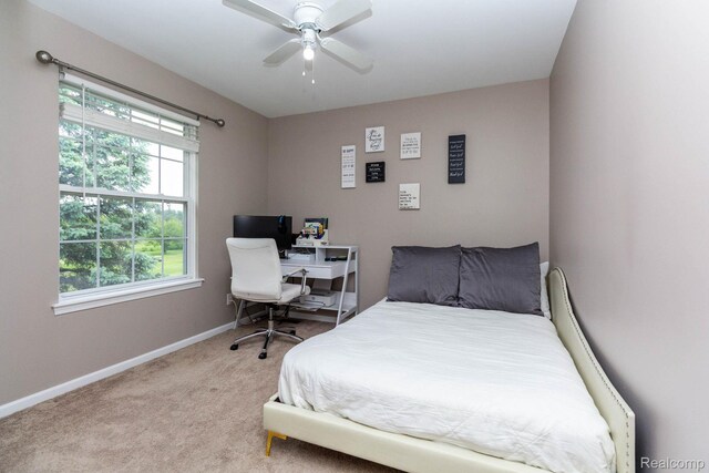 6075 Davison Rd, Burton, MI 48509 - bedroom with light colored carpet, baseboards, a desk, and a ceiling fan
