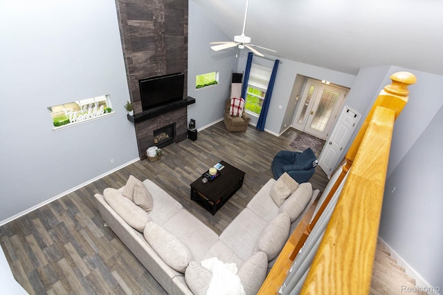 6075 Davison Rd, Burton, MI 48509 - living area with a fireplace, baseboards, a ceiling fan, and lofted ceiling