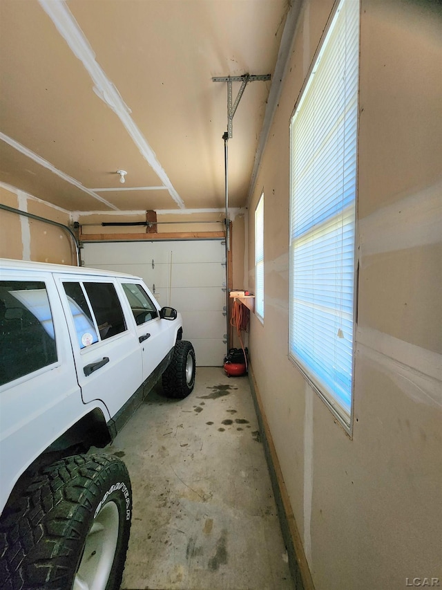 6039 W Morris Lake Rd, Mears, MI 49436 - garage featuring baseboards