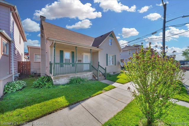 59 E Pleasant St, River Rouge, MI 48218 - bungalow-style home with a porch, a front yard, roof with shingles, and a chimney