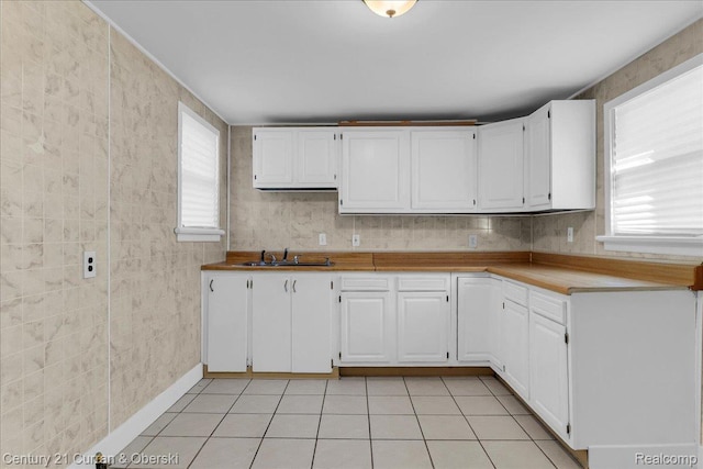 59 E Pleasant St, River Rouge, MI 48218 - kitchen with plenty of natural light, a sink, light tile patterned floors, and white cabinetry