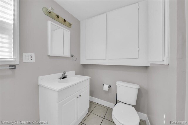 59 E Pleasant St, River Rouge, MI 48218 - bathroom featuring vanity, toilet, tile patterned flooring, and baseboards