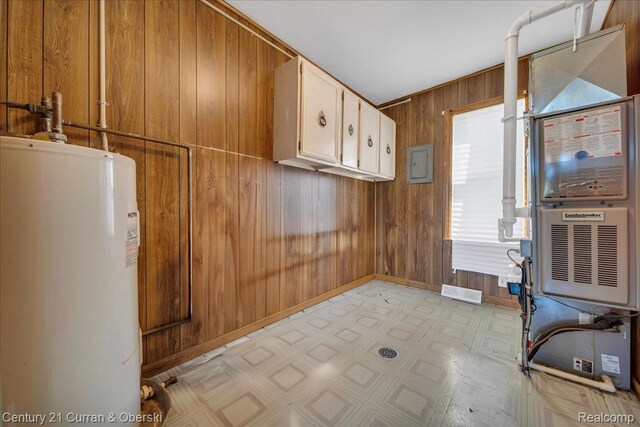 59 E Pleasant St, River Rouge, MI 48218 - laundry room featuring gas water heater, wood walls, light flooring, and baseboards