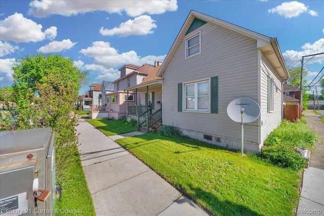 59 E Pleasant St, River Rouge, MI 48218 - view of property exterior with a lawn, crawl space, a porch, and a residential view