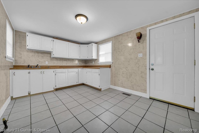 59 E Pleasant St, River Rouge, MI 48218 - kitchen featuring white cabinets, light tile patterned floors, and baseboards