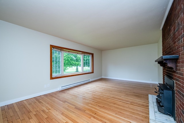 2800 Mayflower Rd, Niles, MI 49120 - unfurnished living room featuring a baseboard heating unit, a wood stove, light wood-style floors, and baseboards