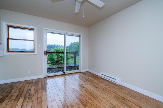 2800 Mayflower Rd, Niles, MI 49120 - spare room featuring a baseboard heating unit, ceiling fan, baseboards, and wood-type flooring