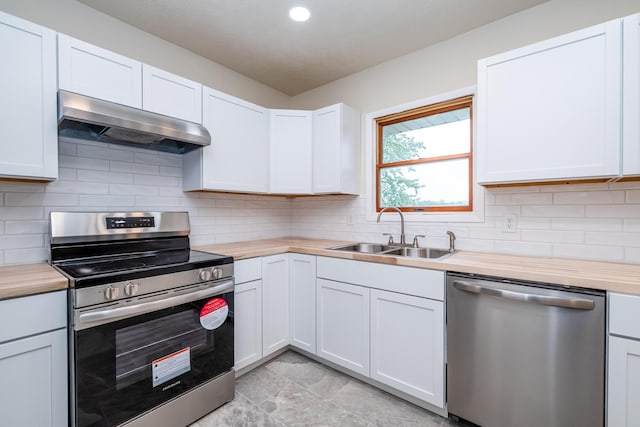 2800 Mayflower Rd, Niles, MI 49120 - kitchen with appliances with stainless steel finishes, a sink, range hood, backsplash, and recessed lighting