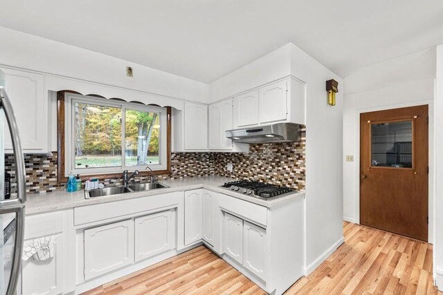 5344 Paw Paw Lake Rd, Coloma, MI 49038 - kitchen featuring under cabinet range hood, a sink, stainless steel gas stovetop, white cabinets, and light countertops