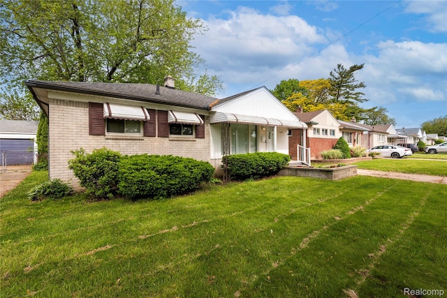 26211 Linwood St, Roseville, MI 48066 - bungalow-style house with brick siding, a front lawn, and a chimney