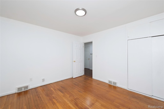 26211 Linwood St, Roseville, MI 48066 - unfurnished bedroom with light wood finished floors, baseboards, crown molding, and a closet