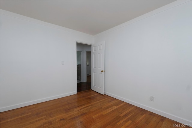 26211 Linwood St, Roseville, MI 48066 - empty room with wood finished floors, baseboards, and ornamental molding
