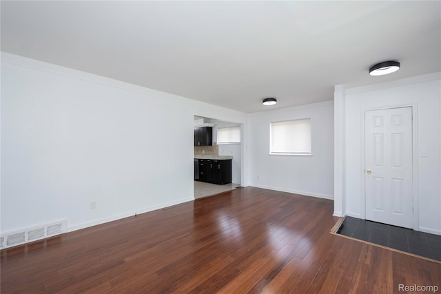 26211 Linwood St, Roseville, MI 48066 - unfurnished living room with dark wood-style flooring and baseboards