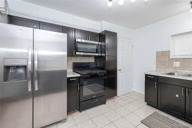 26211 Linwood St, Roseville, MI 48066 - kitchen with appliances with stainless steel finishes, backsplash, light tile patterned floors, a sink, and light stone counters