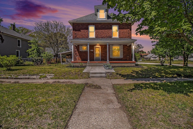 115 N Emily, Ludington, MI 49431 - traditional style home with brick siding, covered porch, and a front yard