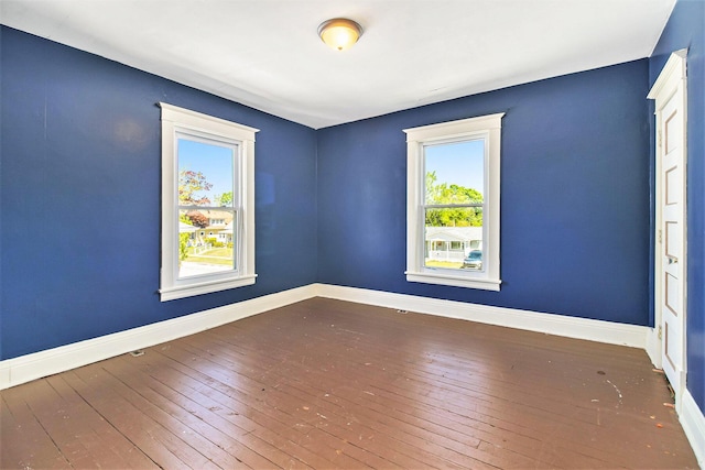 115 N Emily, Ludington, MI 49431 - empty room with baseboards and hardwood / wood-style flooring