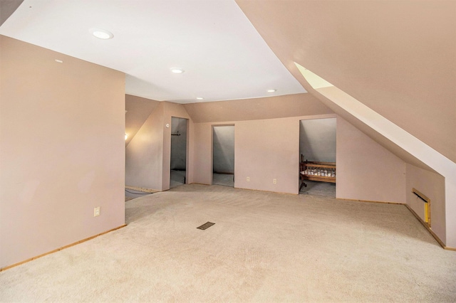 115 N Emily, Ludington, MI 49431 - additional living space with light colored carpet, vaulted ceiling, recessed lighting, and baseboards