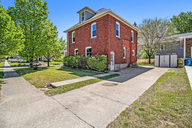 115 N Emily, Ludington, MI 49431 - view of side of property with concrete driveway, a yard, and brick siding