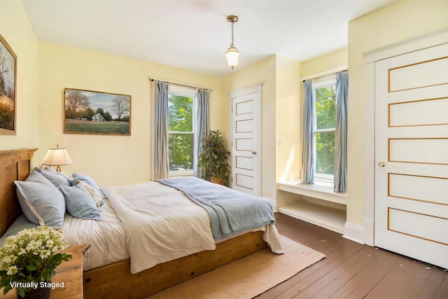 115 N Emily, Ludington, MI 49431 - bedroom featuring hardwood / wood-style flooring and baseboards
