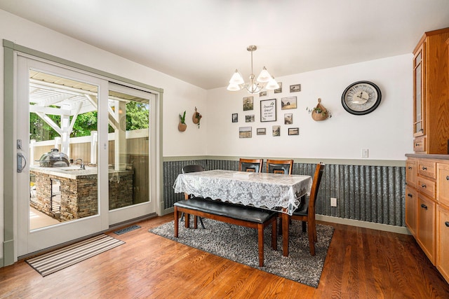 720 Riverside Dr, Constantine, MI 49042 - dining space with a chandelier and wood finished floors