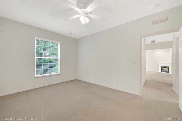 1721 Deepwood Cir, Rochester, MI 48307 - unfurnished room featuring light carpet, ceiling fan, baseboards, and a glass covered fireplace