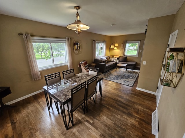 527 Jones St, Grand Ledge, MI 48837 - dining area with dark wood-type flooring and baseboards