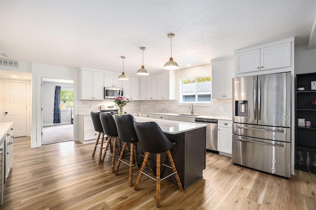 1988 Kregel Ave, Muskegon, MI 49442 - kitchen featuring appliances with stainless steel finishes, a sink, healthy amount of natural light, and light countertops