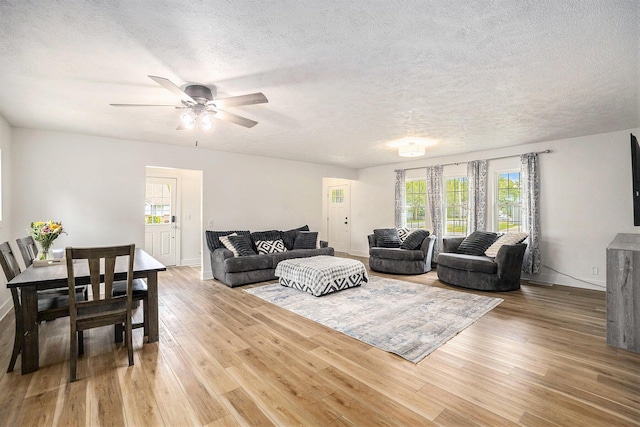 1988 Kregel Ave, Muskegon, MI 49442 - living area featuring a textured ceiling, baseboards, and wood finished floors