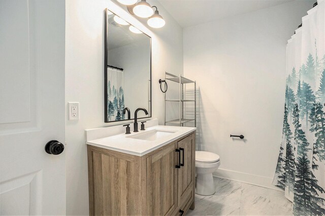 1988 Kregel Ave, Muskegon, MI 49442 - full bathroom featuring vanity, toilet, marble look tiles, and baseboards