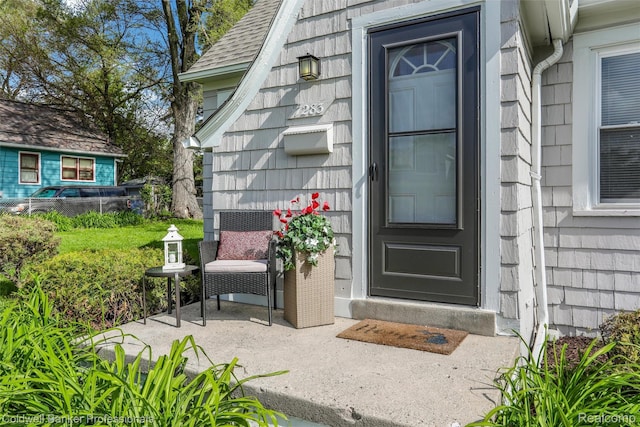 7283 Lozier Ave, Warren, MI 48091 - doorway to property with a shingled roof
