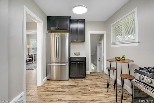 7283 Lozier Ave, Warren, MI 48091 - kitchen featuring stainless steel appliances, light wood finished floors, and baseboards