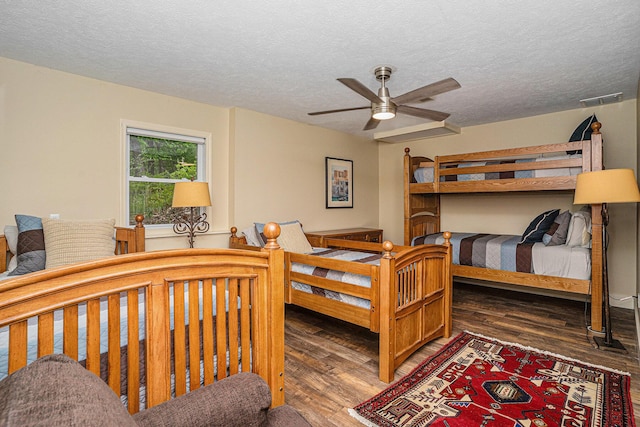 7431 W Buchanan Rd, Shelby, MI 49455 - bedroom featuring wood finished floors, a textured ceiling, and a ceiling fan
